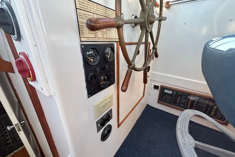Slide: The Image of 1985 Jarvis Newman 36 boat helm with gauges and wooden steering wheel. - 39