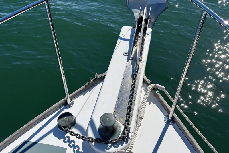 Slide: The Image of Bow of 1985 Jarvis Newman 36 boat with anchor chain and sparkling water. - 44