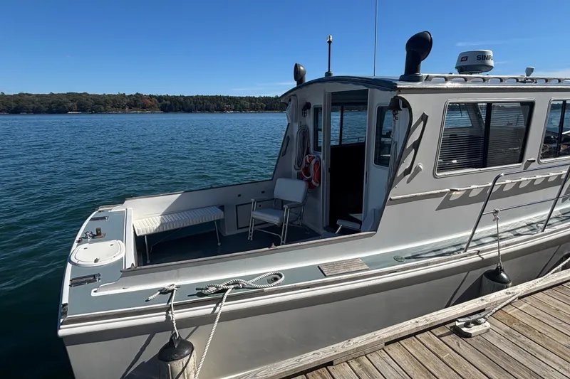 Slide: The Image of 1985 Jarvis Newman 36 boat docked on calm water under clear blue sky. - 5