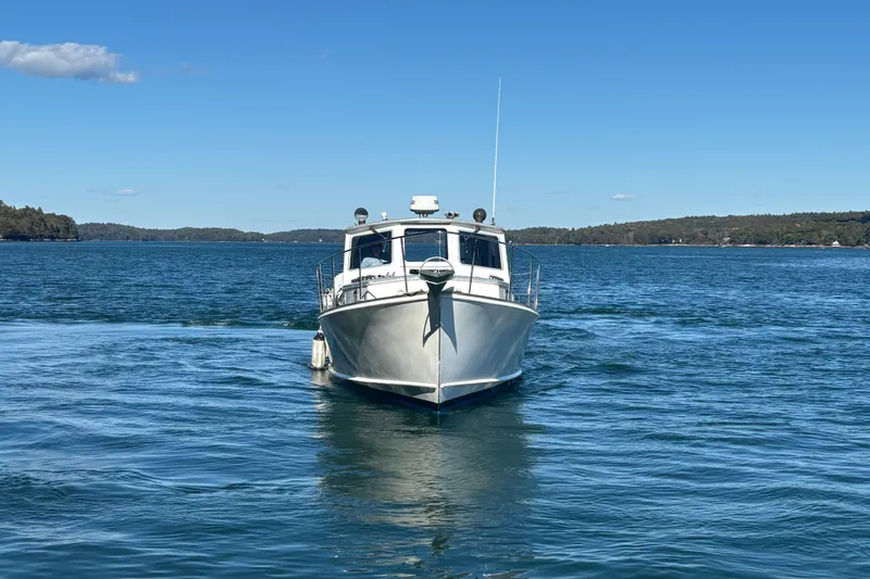 Slide: The Image of 1985 Jarvis Newman 36 boat on calm blue water under clear sky. - 59