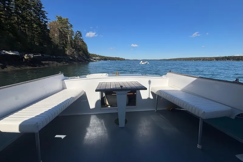 Slide: The Image of 1985 Jarvis Newman 36 boat deck with seating, scenic water view, and clear blue sky. - 9