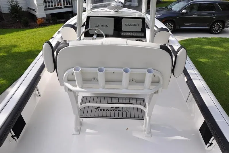 Slide: The Image of 2024 Tidewater 2300 Carolina Bay boat interior with Garmin displays and rod holders. - 10