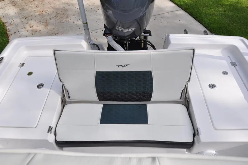 Slide: The Image of 2024 Tidewater 2300 Carolina Bay boat with cushioned seating and powerful engine. - 12