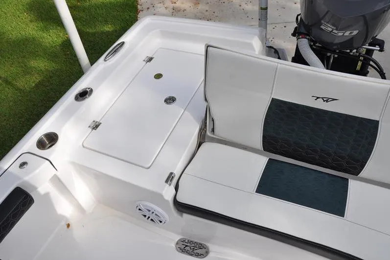 Slide: The Image of 2024 Tidewater 2300 Carolina Bay boat interior with seating and storage compartments. - 13