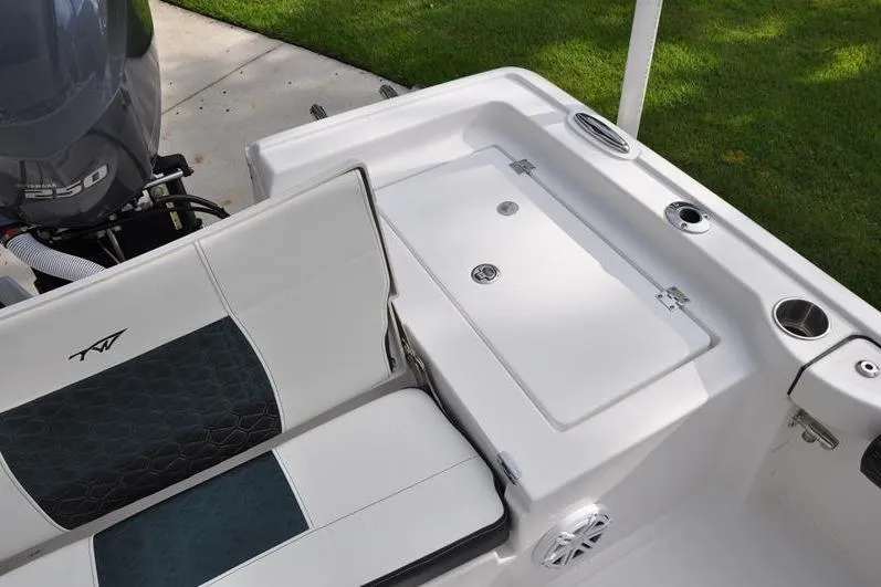 Slide: The Image of 2024 Tidewater 2300 Carolina Bay boat interior with seating and storage compartment. - 14