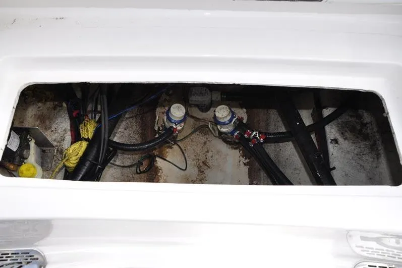 Slide: The Image of Bilge area of 2024 Tidewater 2300 Carolina Bay boat, showing pumps and wiring. - 17