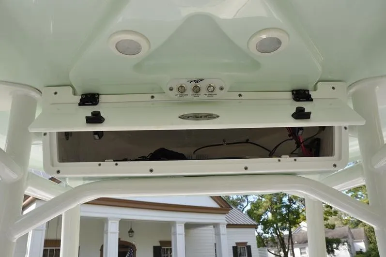 Slide: The Image of 2024 Tidewater 2300 Carolina Bay boat console with open storage compartment and controls. - 25