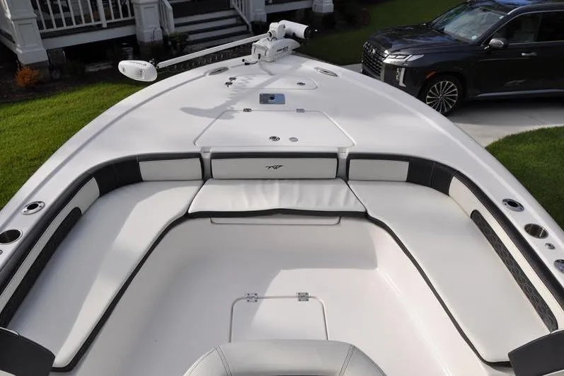 Slide: The Image of 2024 Tidewater 2300 Carolina Bay boat interior with cushioned seating and sleek design. - 29
