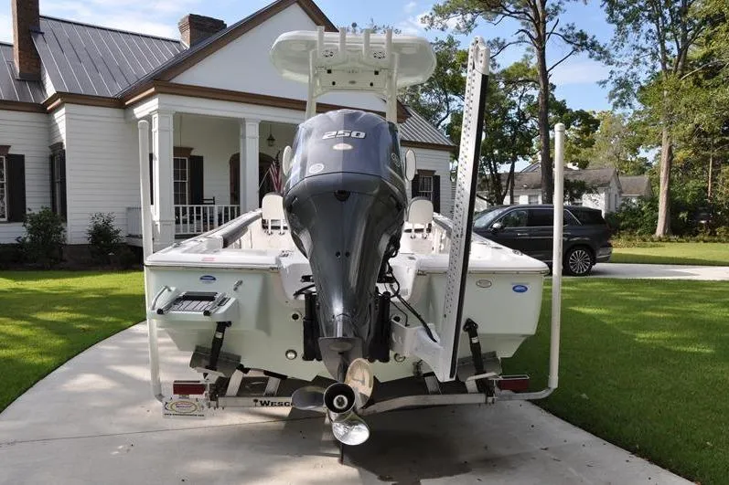Slide: The Image of 2024 Tidewater 2300 Carolina Bay boat with powerful engine, parked in front of a house. - 3