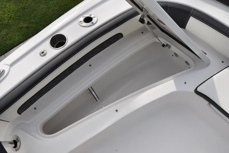 Slide: The Image of 2024 Tidewater 2300 Carolina Bay boat storage compartment with open hatch. - 32