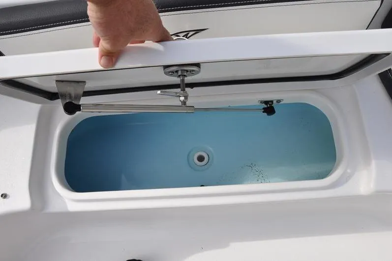 Slide: The Image of 2024 Tidewater 2300 Carolina Bay livewell with open lid, showcasing interior details. - 33