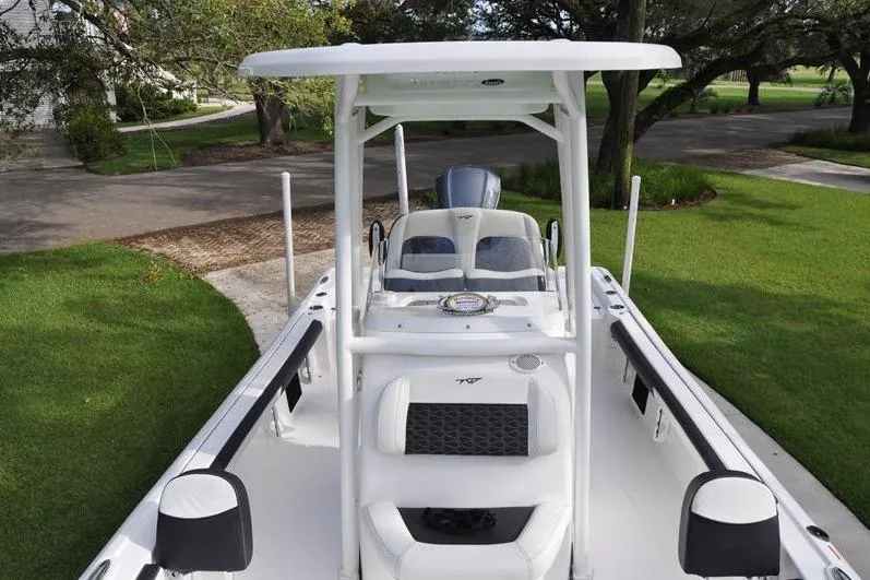 Slide: The Image of 2024 Tidewater 2300 Carolina Bay boat with T-top, parked on grass. - 38