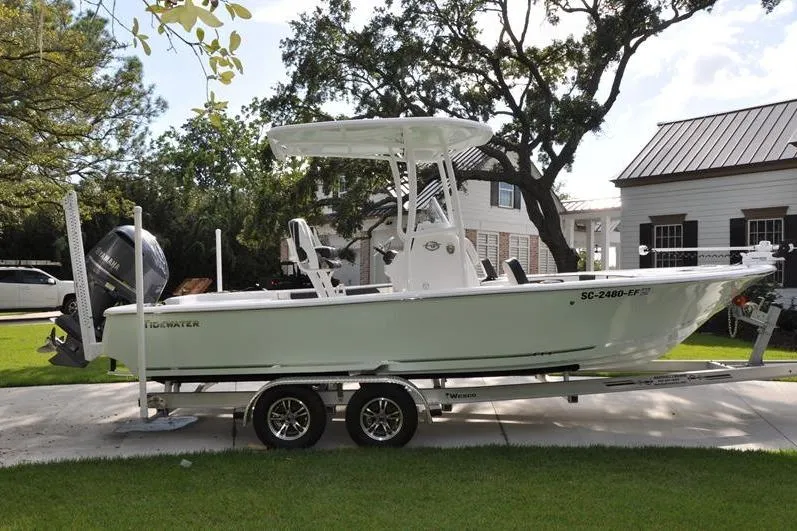 Slide: The Image of 2024 Tidewater 2300 Carolina Bay boat on trailer, parked in residential driveway. - 5