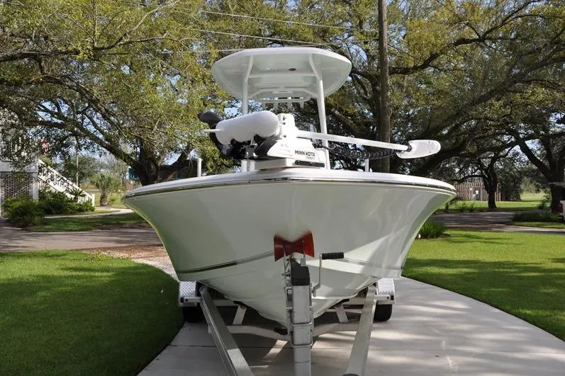 Slide: The Image of 2024 Tidewater 2300 Carolina Bay boat on trailer, parked in a driveway. - 7