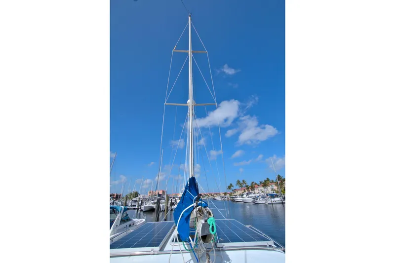 Slide: The Image of 1987 Morgan 43 CC sailboat docked in marina under clear blue sky. - 15