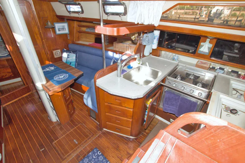 Slide: The Image of Interior of 1987 Morgan 43 CC sailboat with kitchen and seating area. - 31