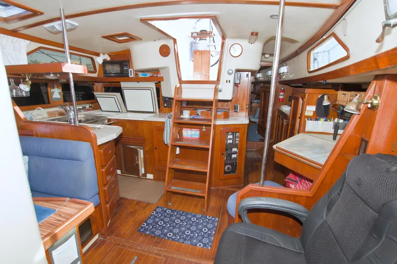 Slide: The Image of Interior of 1987 Morgan 43 CC sailboat with wooden furnishings and cozy seating area. - 32