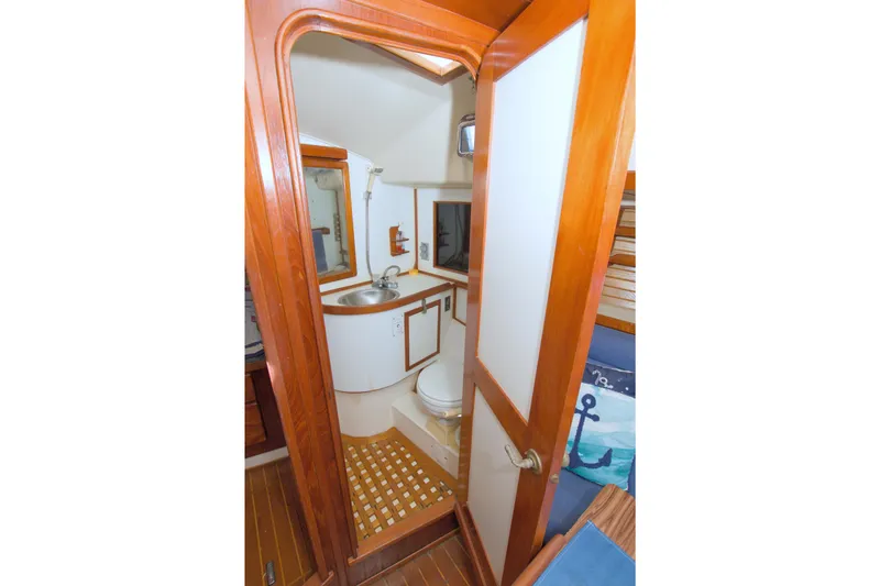 Slide: The Image of 1987 Morgan 43 CC yacht bathroom with wooden accents and nautical decor. - 43