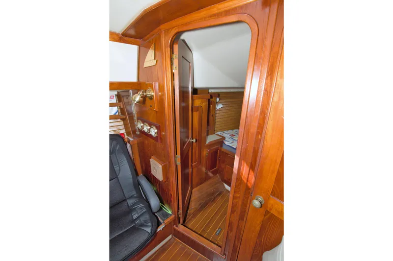 Slide: The Image of 1987 Morgan 43 CC yacht interior with wooden finish and cozy cabin view. - 44