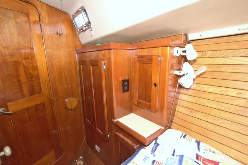 Slide: The Image of 1987 Morgan 43 CC yacht interior with wooden cabinetry and cozy lighting. - 46