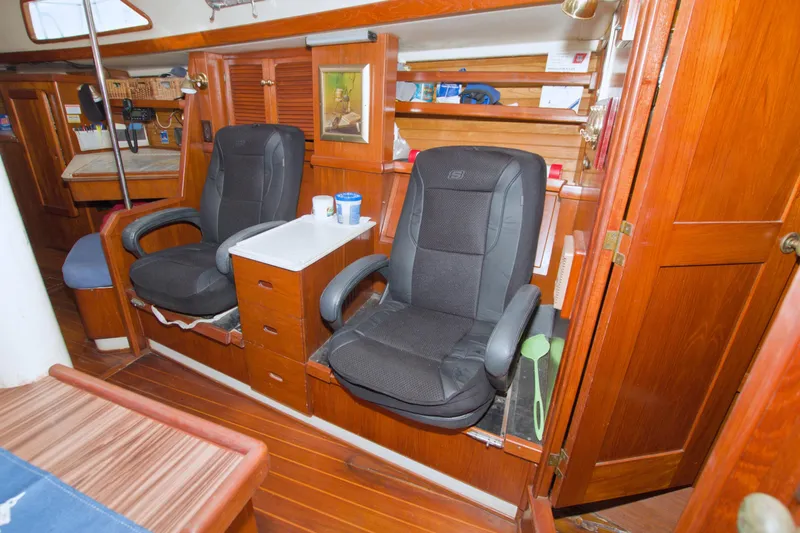 Slide: The Image of Interior of 1987 Morgan 43 CC sailboat with comfortable seating and wooden cabinetry. - 49