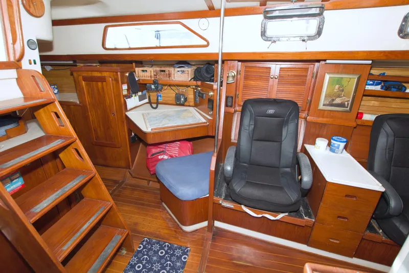 Slide: The Image of Interior of 1987 Morgan 43 CC sailboat with wooden furnishings and navigation station. - 50