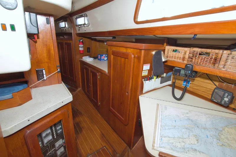 Slide: The Image of Interior of 1987 Morgan 43 CC sailboat with wooden cabinetry and navigation equipment. - 51