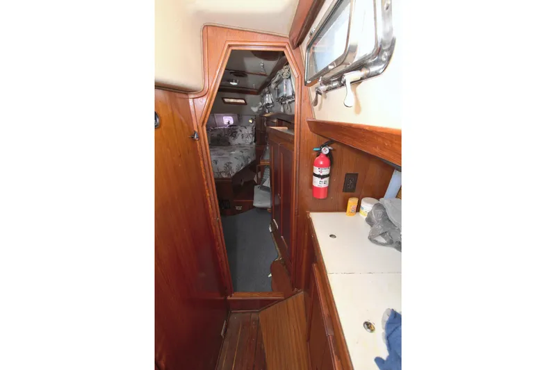 Slide: The Image of Interior of 1987 Morgan 43 CC sailboat with wooden cabinetry and fire extinguisher. - 52