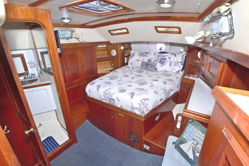 Slide: The Image of Luxurious 1987 Morgan 43 CC yacht interior with cozy bedroom and elegant wood finish. - 54