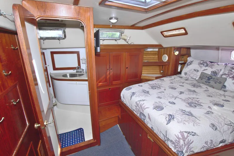 Slide: The Image of Luxurious 1987 Morgan 43 CC yacht interior with cozy bedroom and compact bathroom. - 57