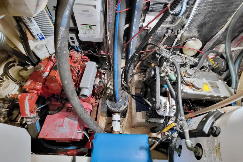 Slide: The Image of Engine room of a 1987 Morgan 43 CC sailboat, showcasing mechanical components and wiring. - 67