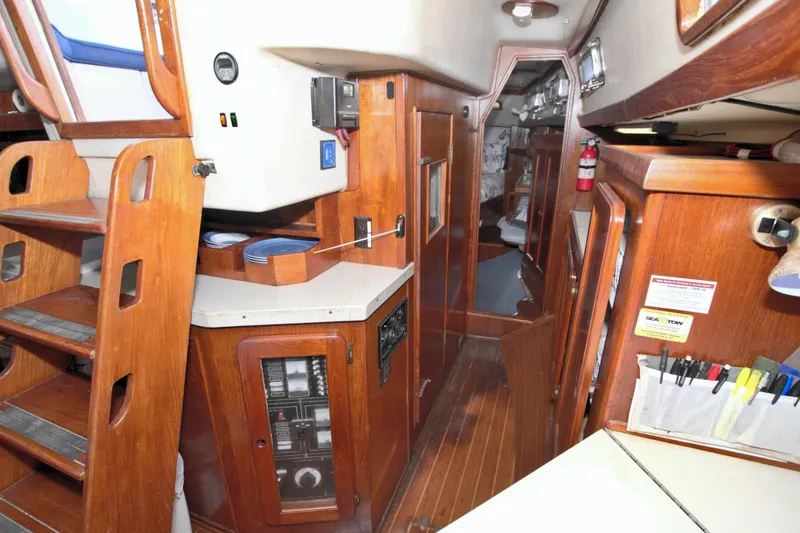 Slide: The Image of Interior of 1987 Morgan 43 CC sailboat with wooden cabinetry and navigation equipment. - 69