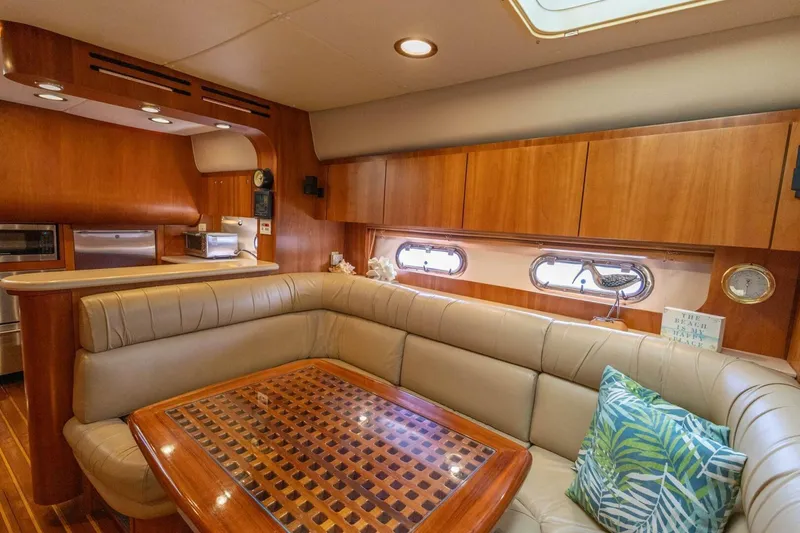 Slide: The Image of Luxurious interior of 2000 Tiara Yachts 5200 Express with elegant wood finishes and plush seating. - 14