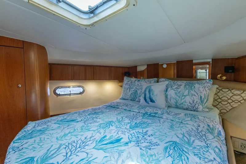 Slide: The Image of Luxurious cabin interior of 2000 Tiara Yachts 5200 Express with elegant bedding. - 16