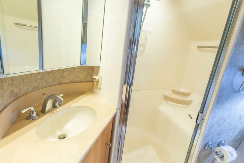 Slide: The Image of Luxurious bathroom in 2000 Tiara Yachts 5200 Express, featuring a sleek sink and shower. - 20