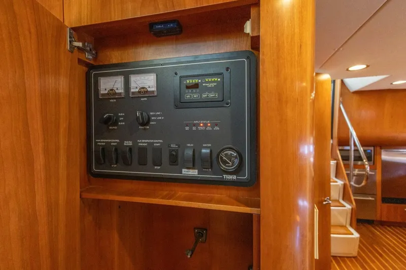 Slide: The Image of Electrical control panel on 2000 Tiara Yachts 5200 Express, featuring gauges and switches. - 21