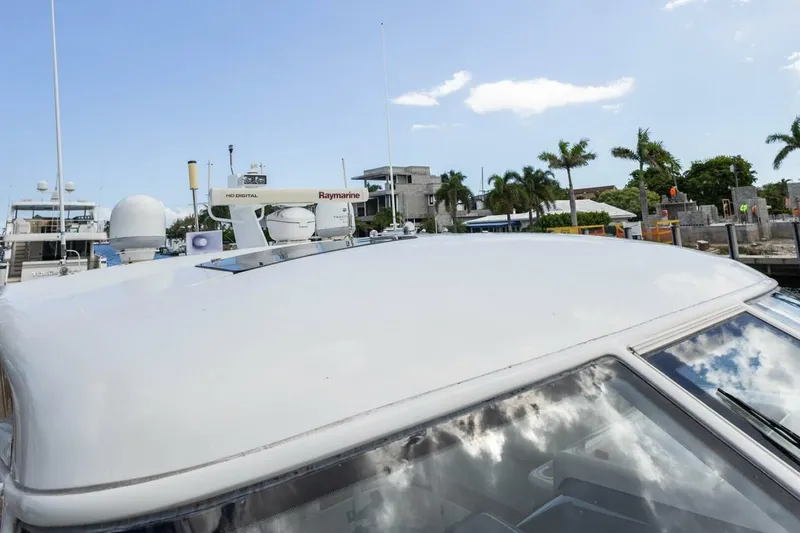 Slide: The Image of 2000 Tiara Yachts 5200 Express with Raymarine equipment, docked near palm trees. - 28