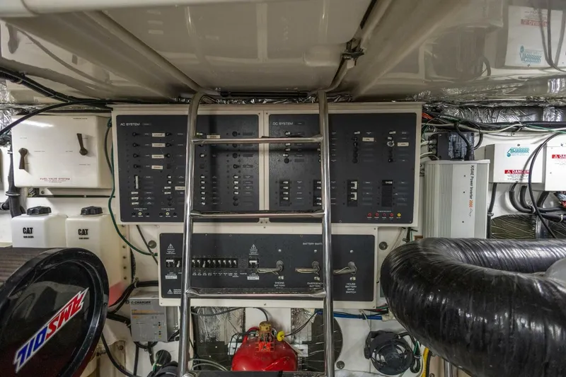 Slide: The Image of Engine room of 2000 Tiara Yachts 5200 Express, featuring control panels and equipment. - 29