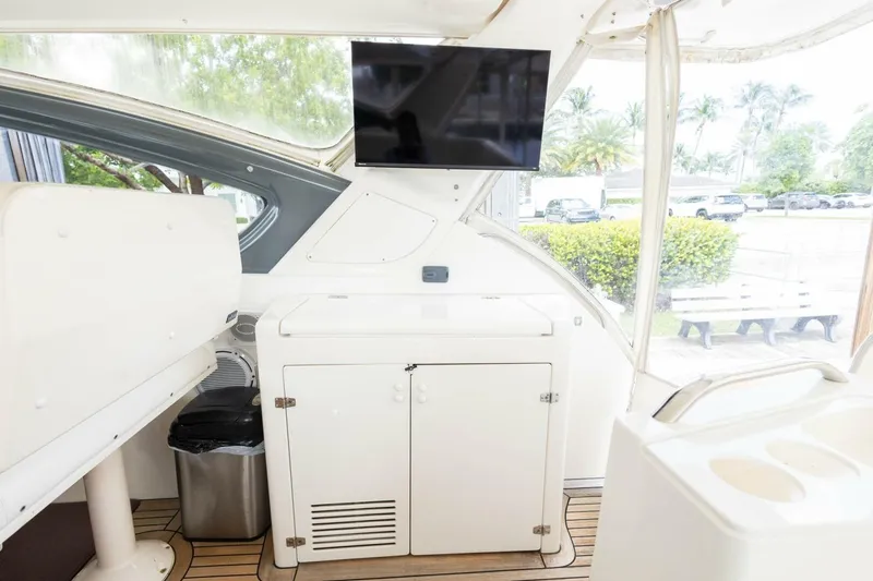 Slide: The Image of Interior of 2000 Tiara Yachts 5200 Express with TV and storage cabinet. - 5