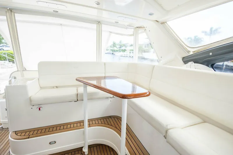 Slide: The Image of Luxurious interior of 2000 Tiara Yachts 5200 Express with white seating and wooden table. - 6