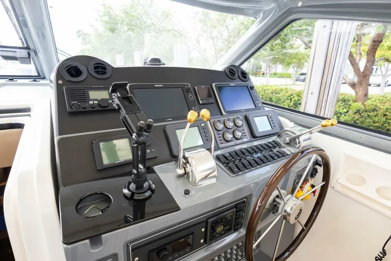 Slide: The Image of Control panel of a 2000 Tiara Yachts 5200 Express, featuring navigation and steering equipment. - 8