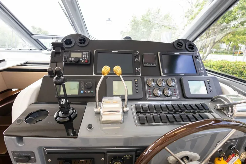 Slide: The Image of Cockpit of 2000 Tiara Yachts 5200 Express with navigation controls and displays. - 9