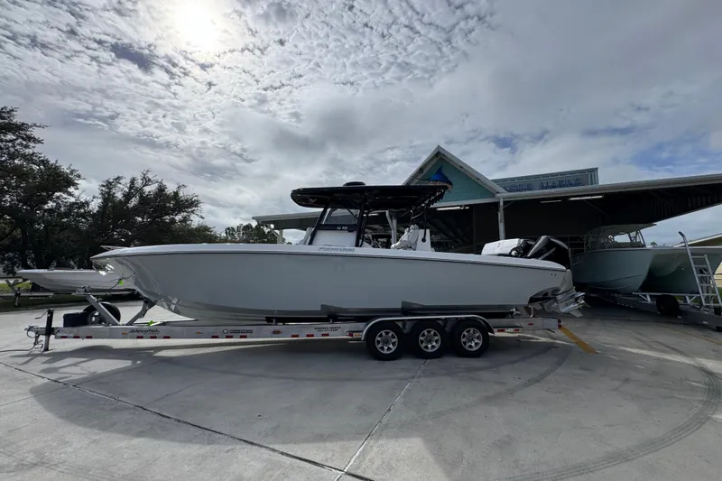 The Image of 2026 Fountain 34 Tournament Edition boat on trailer under cloudy sky. - 1