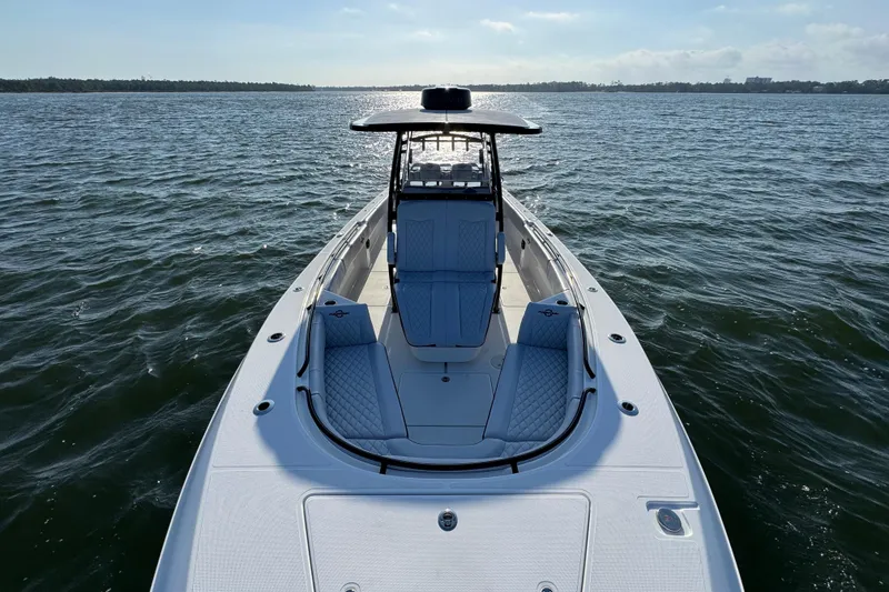 Slide: The Image of 2026 Fountain 34 Tournament Edition boat on open water, showcasing sleek design and seating. - 19