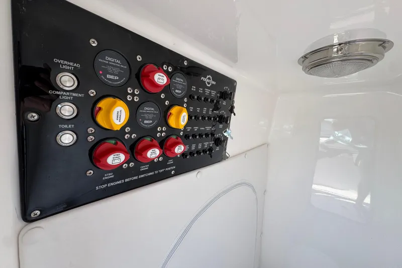 Slide: The Image of Control panel inside 2026 Fountain 34 Tournament Edition boat, featuring various switches and indicators. - 23