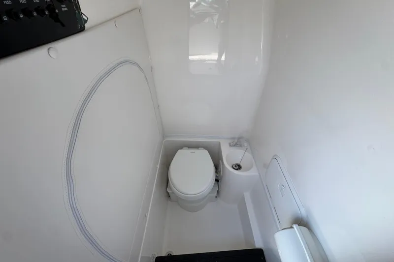 Slide: The Image of 2026 Fountain 34 Tournament Edition boat interior with compact marine toilet. - 24