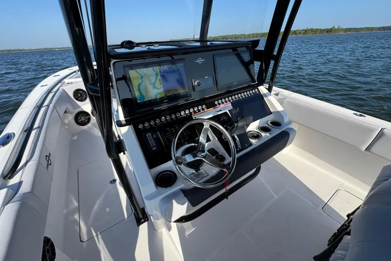 Slide: The Image of 2026 Fountain 34 Tournament Edition boat dashboard with navigation screens on open water. - 26