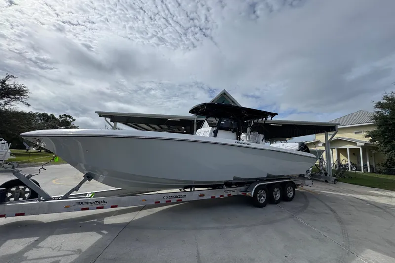 Slide: The Image of 2026 Fountain 34 Tournament Edition boat on trailer, parked outdoors under cloudy sky. - 3