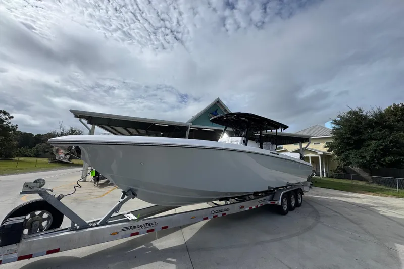 Slide: The Image of 2026 Fountain 34 Tournament Edition boat on trailer under cloudy sky. - 4