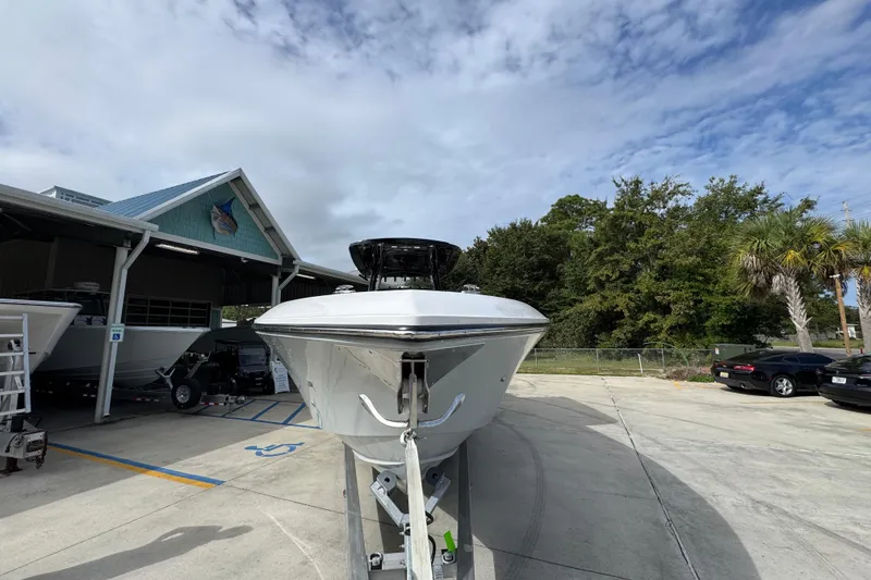 Slide: The Image of 2026 Fountain 34 Tournament Edition boat on trailer, parked outdoors under cloudy sky. - 6